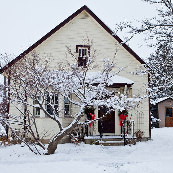 cream house with snow