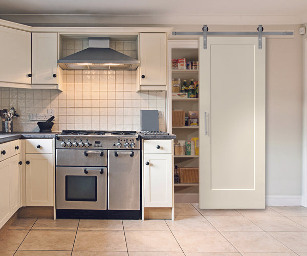 white kitchen with white barn door